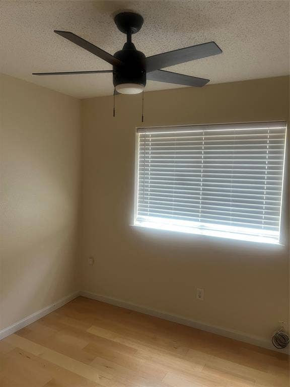 121 Brookside Drive, Duncanville, TX 75137 Room featuring light wood-finish flooring, a window with horizontal blinds, and a ceiling fan with integrated lighting