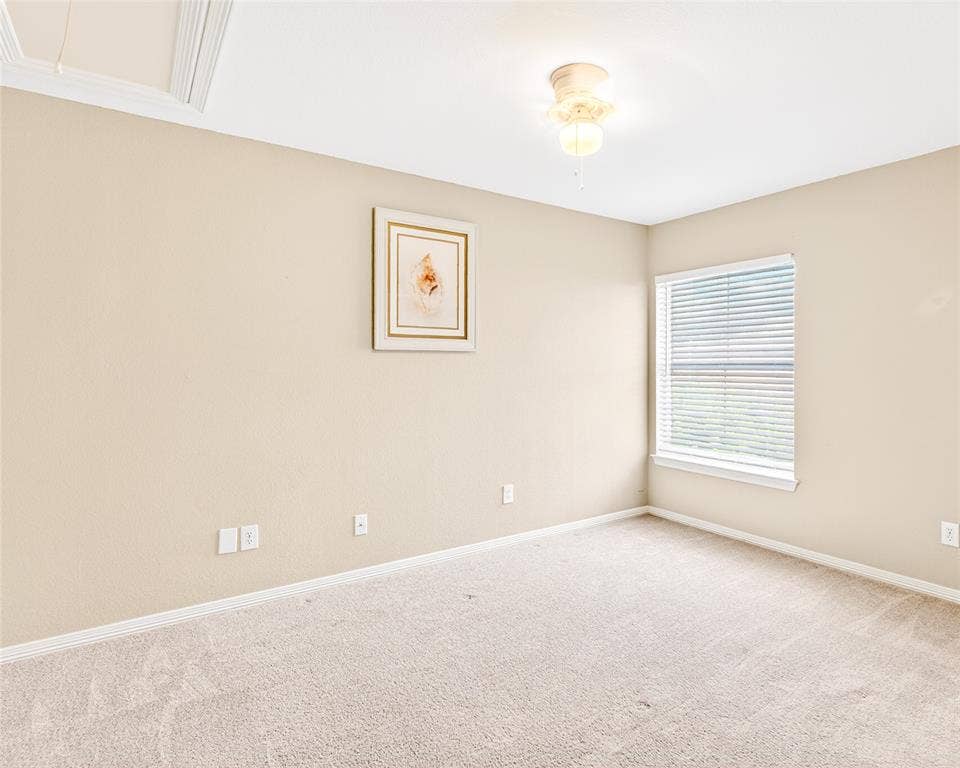 6005 Pin Oak Drive, McKinney, TX 75072 Carpeted room with neutral-toned walls, a single window with blinds, and a ceiling-mounted light fixture