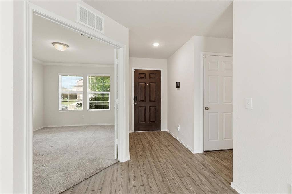 Natural light and beautiful floors as you entry the home