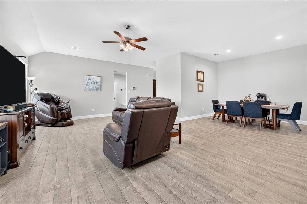 829 Poppie Lane, Midlothian, TX 76065 Spacious open-concept interior featuring light wood-finish flooring throughout