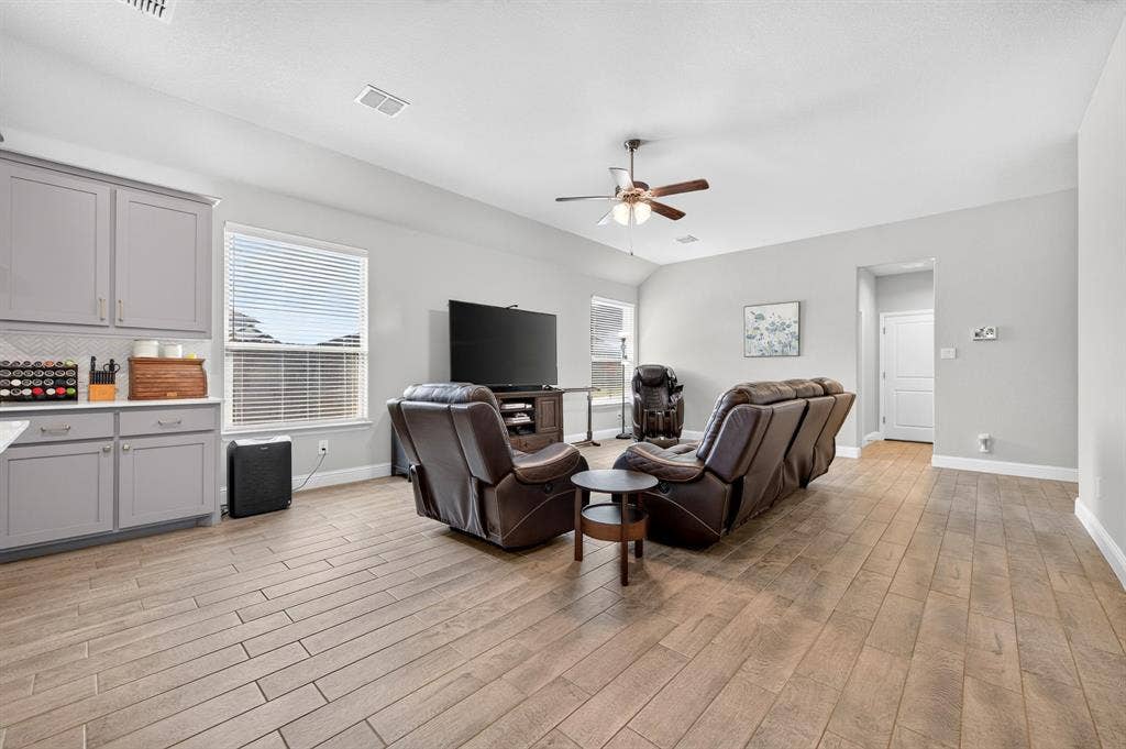 829 Poppie Lane, Midlothian, TX 76065 Open-concept living area with wood-finish tile flooring, a vaulted ceiling, and recessed lighting