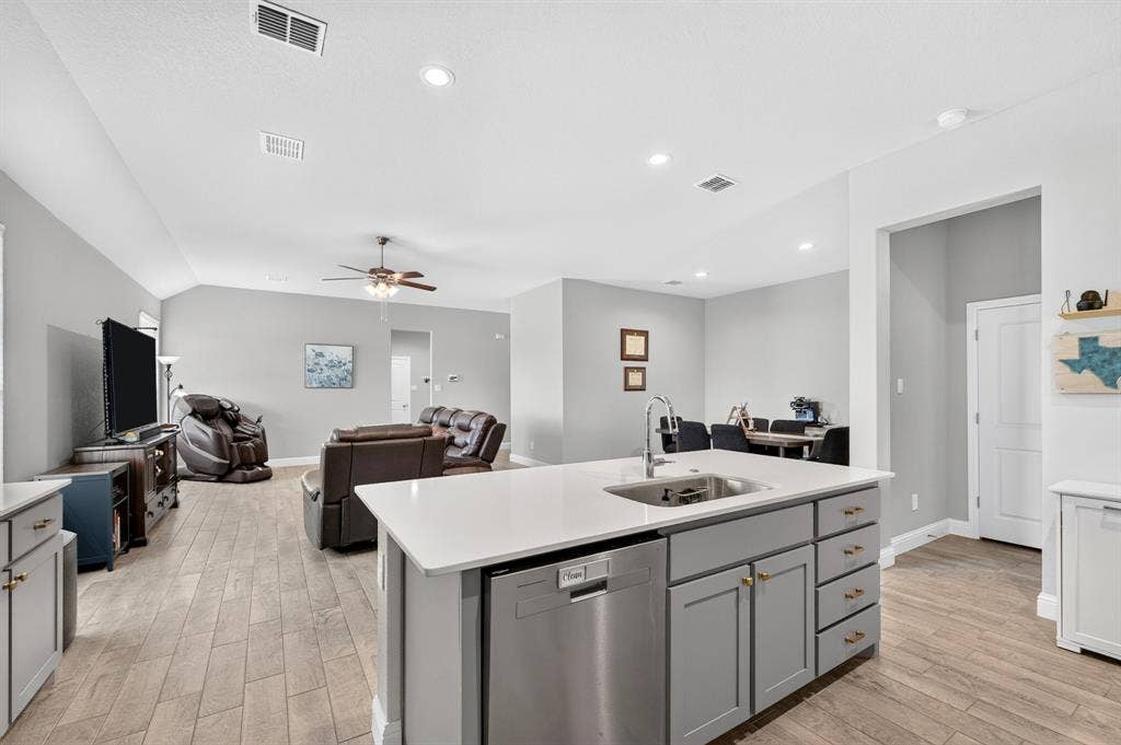 829 Poppie Lane, Midlothian, TX 76065 Open-concept living space featuring wood-finish flooring, recessed lighting, and a vaulted ceiling with a ceiling fan