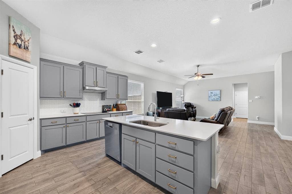 829 Poppie Lane, Midlothian, TX 76065 Kitchen featuring gray cabinetry with gold-finish hardware, white countertops, and a white subway tile backsplash