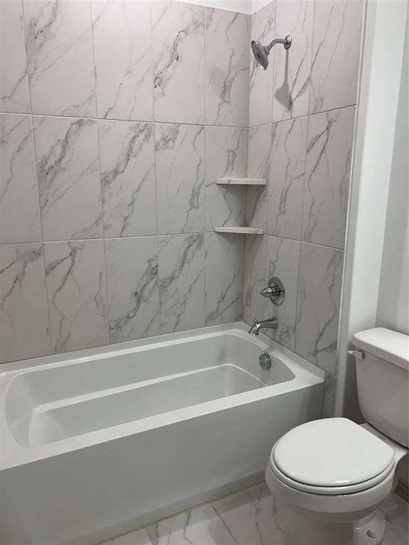 6041 Roper Road, McKinney, TX 75070 Bathtub and shower combination featuring white marble-look tile surround and chrome fixtures