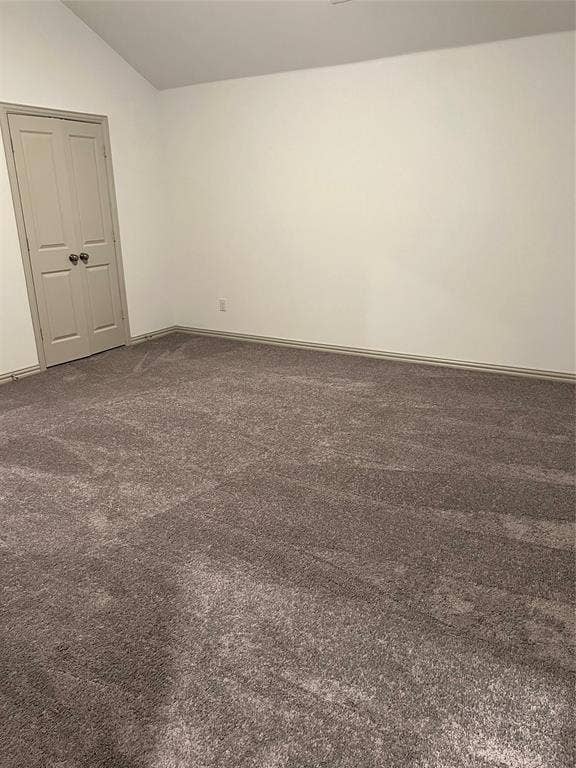 6041 Roper Road, McKinney, TX 75070 Spacious room featuring vaulted ceilings, light-toned walls, and a neutral carpet
