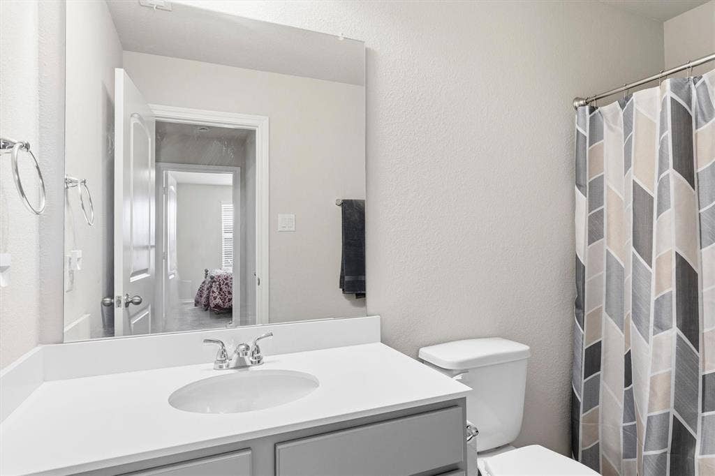 702 Matador Lane, Arlington, TX 76002 Bathroom vanity featuring a light countertop with an integrated sink and a chrome faucet
