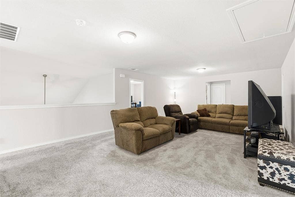702 Matador Lane, Arlington, TX 76002 Spacious bonus room featuring light gray carpeting, recessed ceiling lighting, a white painted half-wall, and a ceiling access panel