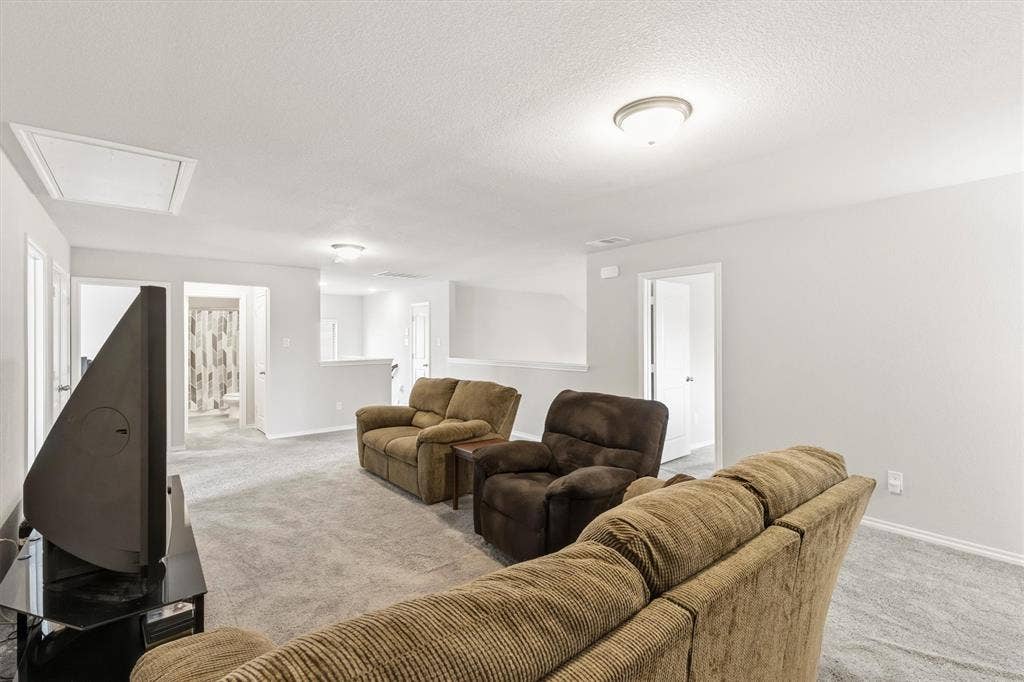 702 Matador Lane, Arlington, TX 76002 Spacious secondary living area featuring light gray wall paint, light gray carpeting, and white trim
