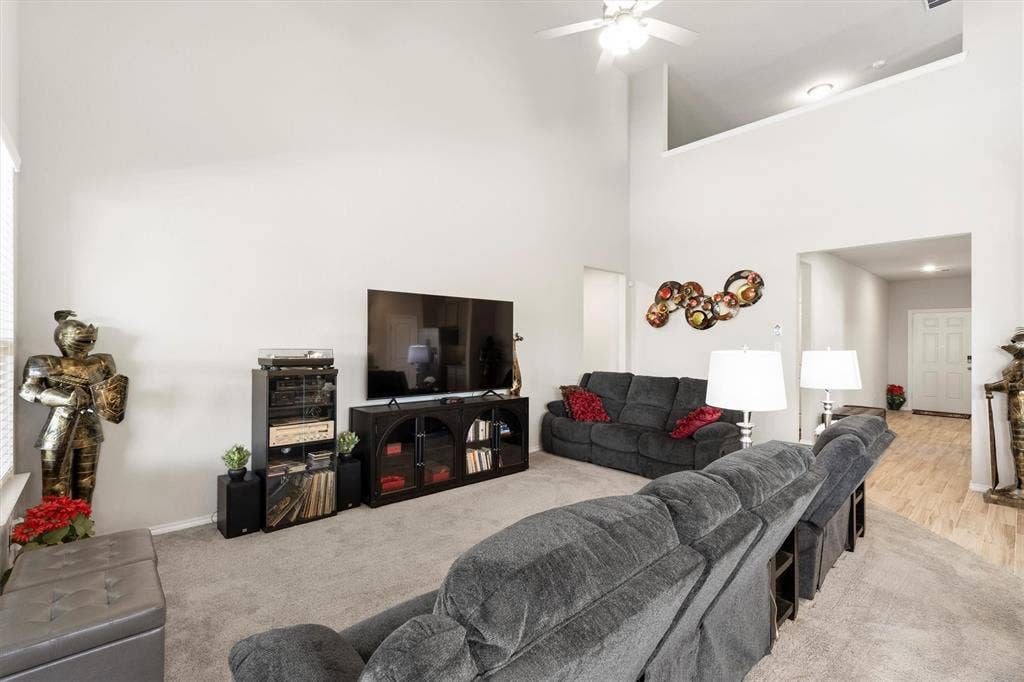 702 Matador Lane, Arlington, TX 76002 Expansive living area featuring soaring ceilings and a ceiling fan with integrated lighting