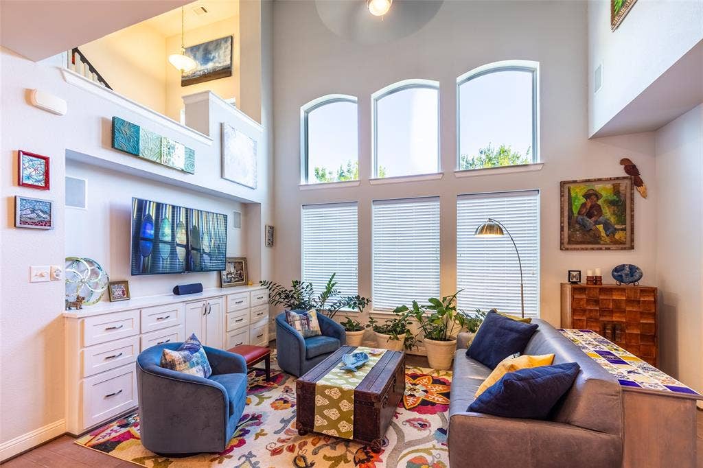 Downstair living room area featuring high arched windows providing abundant natural light