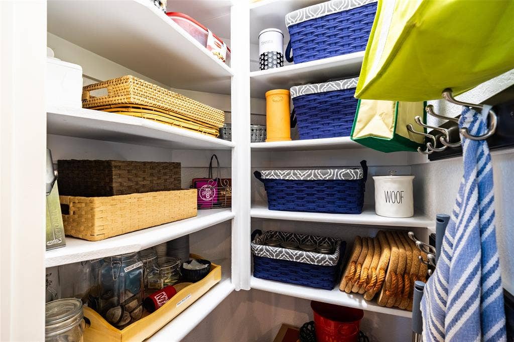 Built-in shelving providing organized storage within a dedicated pantry space