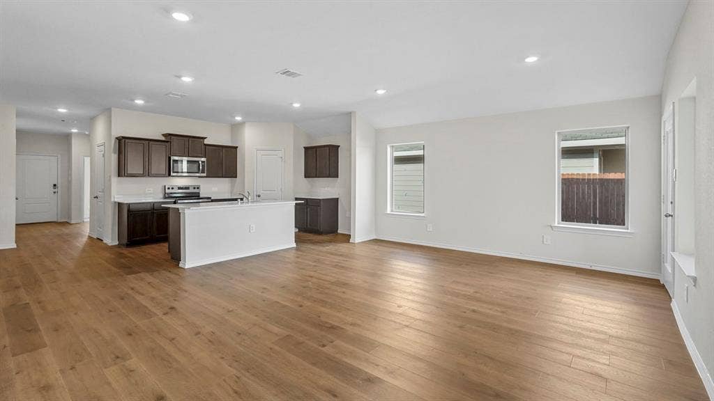 1953 Freeman Street, Tyler, TX 75704 Open-concept living area featuring wood-finish flooring, recessed lighting, and a kitchen island