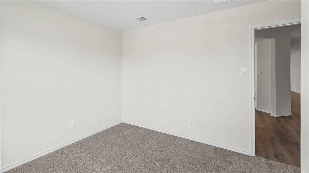 1953 Freeman Street, Tyler, TX 75704 Room featuring neutral wall tones, gray carpeting, and white trim