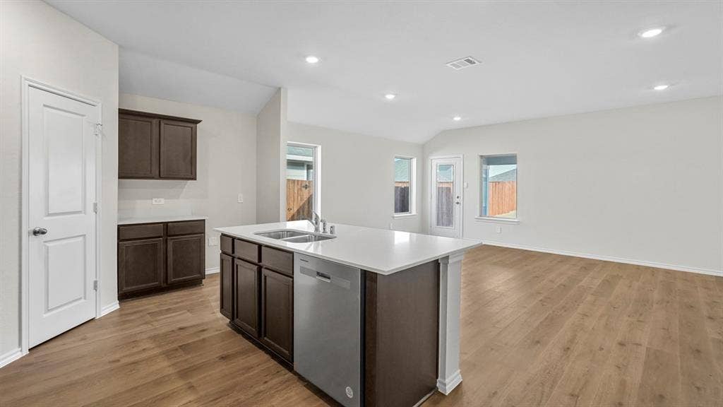 1953 Freeman Street, Tyler, TX 75704 Open-concept living space featuring wood-finish flooring, recessed lighting, and a kitchen island with an integrated sink and dishwasher