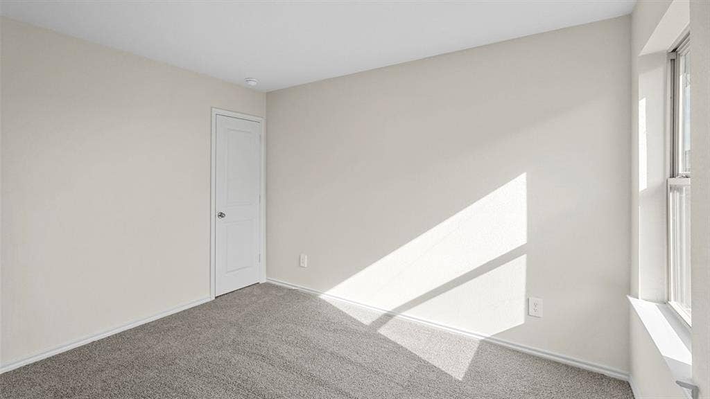 1953 Freeman Street, Tyler, TX 75704 Neutral-toned room featuring a single window and recessed lighting