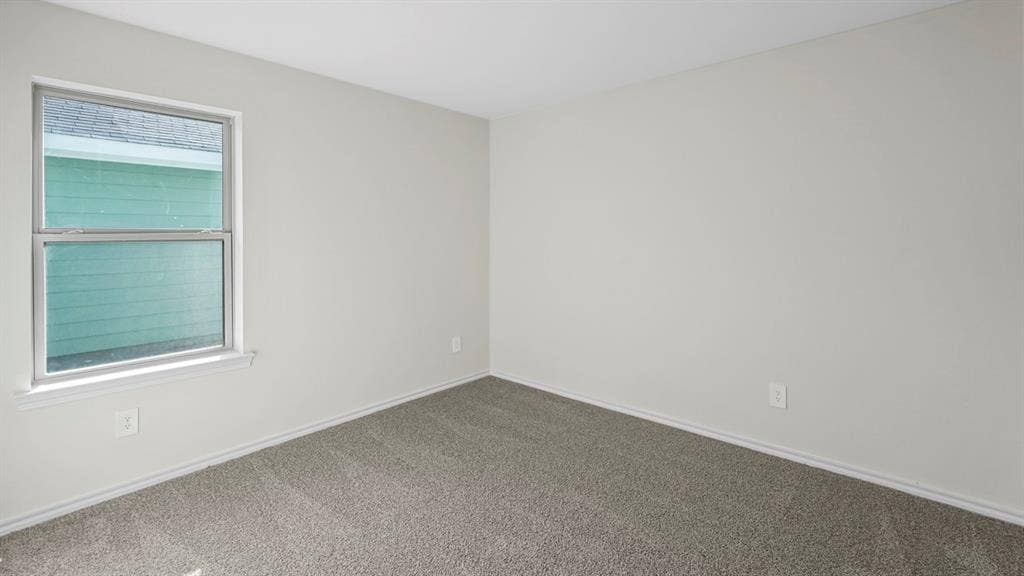 1953 Freeman Street, Tyler, TX 75704 Neutral tone walls with white trim and a double-hung window