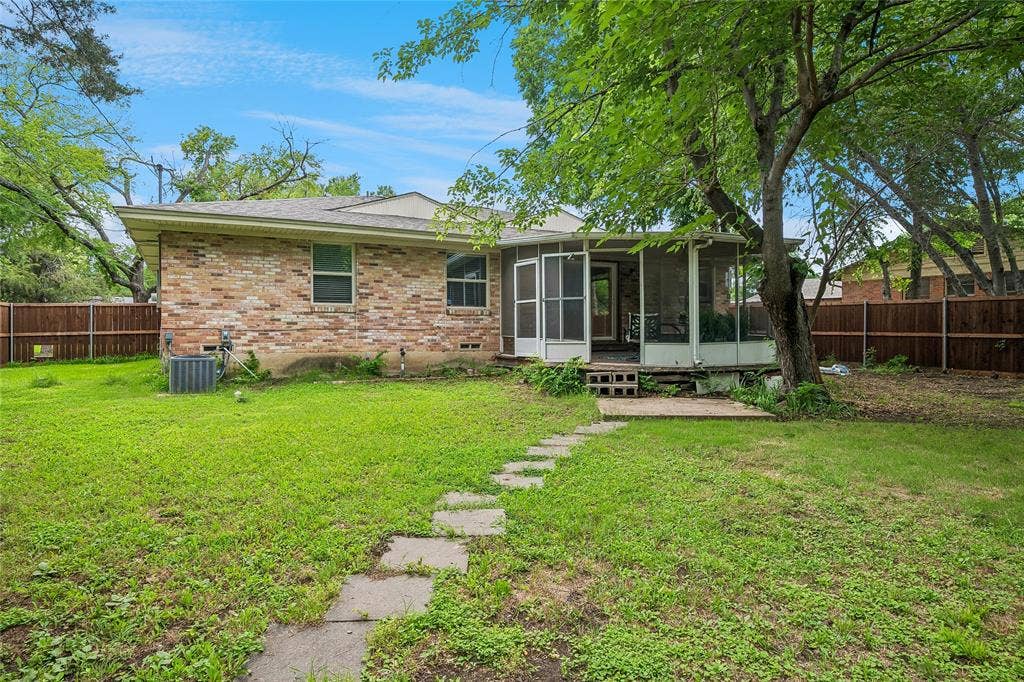 13430 Challaburton Drive, Farmers Branch, TX 75234 Expansive backyard featuring a screened porch, mature tree coverage, brick exterior, and a privacy fence