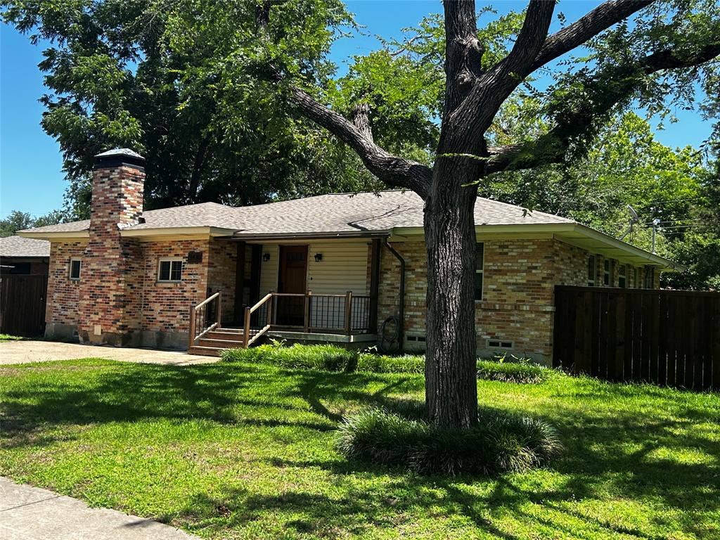 13430 Challaburton Drive, Farmers Branch, TX 75234 Single-story residence featuring a brick and siding exterior, a prominent brick chimney, and a front porch with wood steps and railings