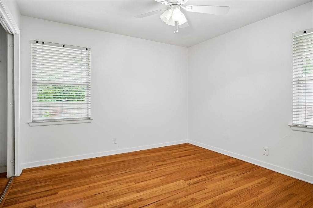 13430 Challaburton Drive, Farmers Branch, TX 75234 Hardwood flooring, white wall paneling, ceiling fan with light fixture, window with blinds, and white trim