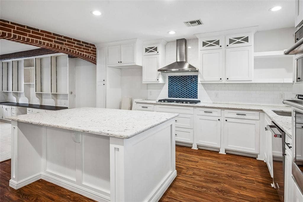 13430 Challaburton Drive, Farmers Branch, TX 75234 Open concept living space featuring a carpeted area with built-in white cabinetry and a dark wood-finish countertop