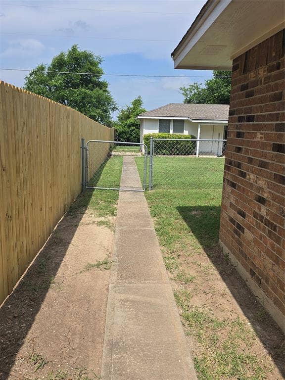 9 Marvin Gardens, Midlothian, TX 76065 Sidewalk from garage to building and deck in the rear of the property