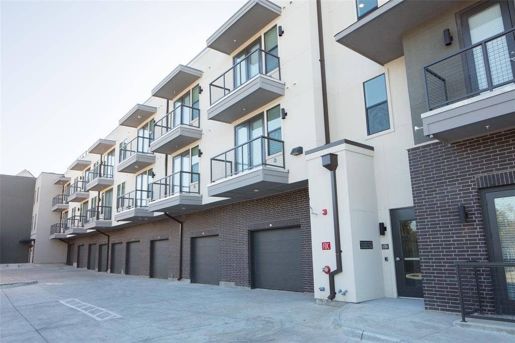 901 N Zang Boulevard, #211, Dallas, TX 75208 View of property featuring a garage
