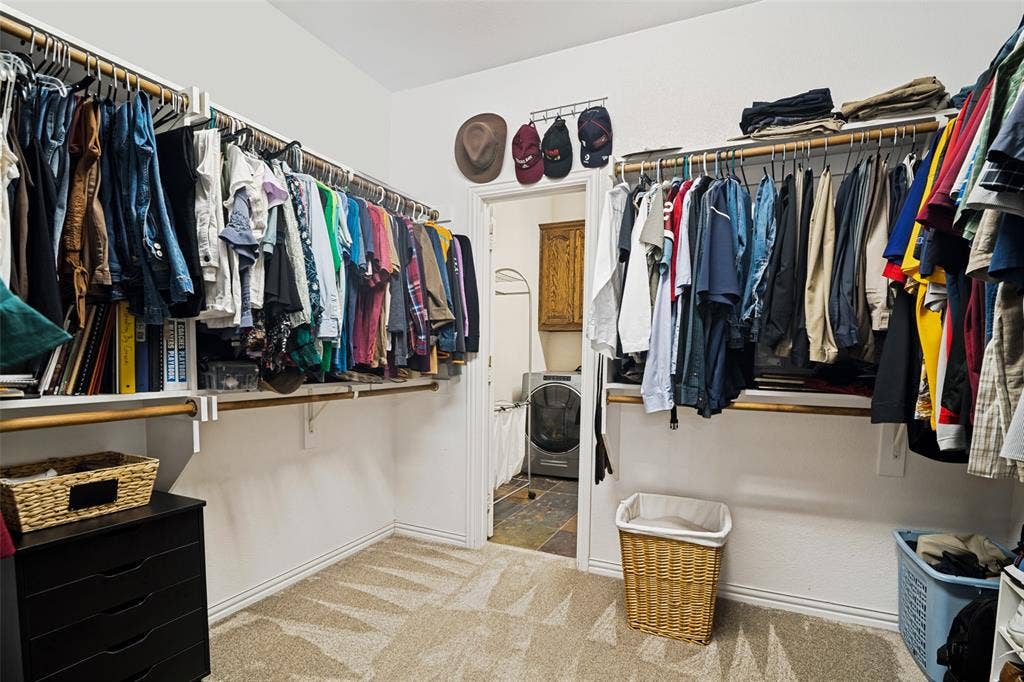 4305 Loch Haven Court, McKinney, TX 75072 Walk-in closet with carpeted flooring, white walls, and extensive built-in shelving