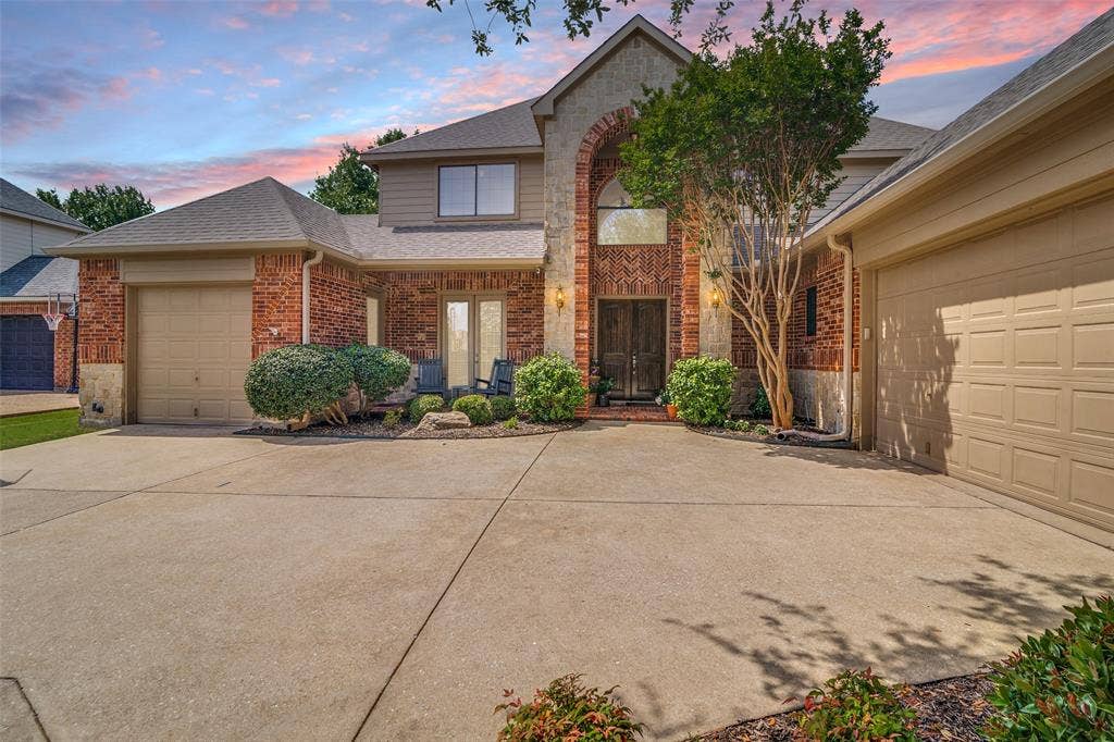 4305 Loch Haven Court, McKinney, TX 75072 Brick exterior with stone accents, arched entryway, double-door entry, and two attached garages
