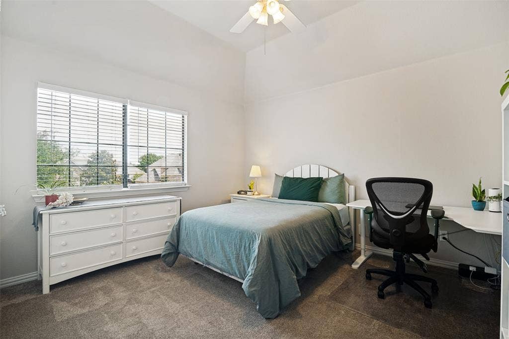 4305 Loch Haven Court, McKinney, TX 75072 Bedroom with vaulted ceiling, ceiling fan, and double window featuring horizontal blinds