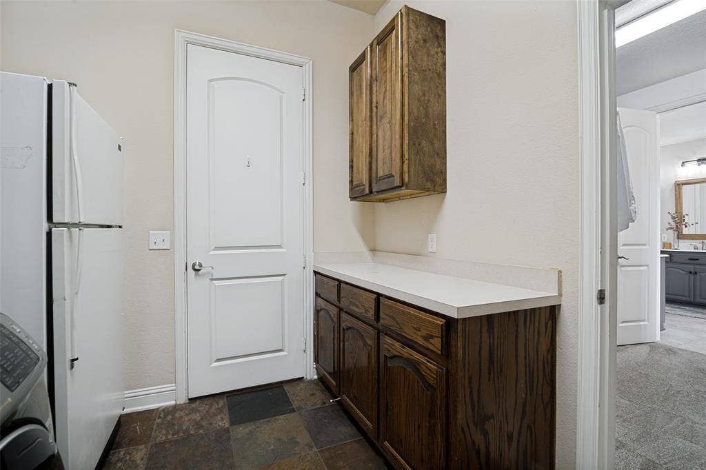 4305 Loch Haven Court, McKinney, TX 75072 Additional view in spacious laundry room that shows extra counter space and cabinetry