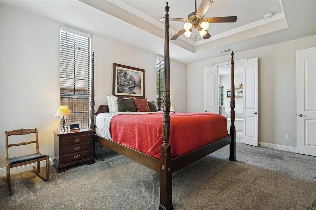 4305 Loch Haven Court, McKinney, TX 75072 Spacious room featuring a tray ceiling with a ceiling fan, light gray carpeting, and multiple windows with blinds