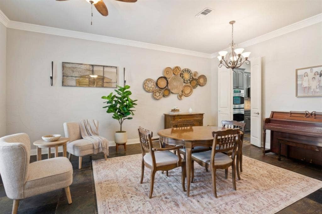 4305 Loch Haven Court, McKinney, TX 75072 Virtually staged. Formal dining space featuring dark flooring, crown molding, and a five-light chandelier