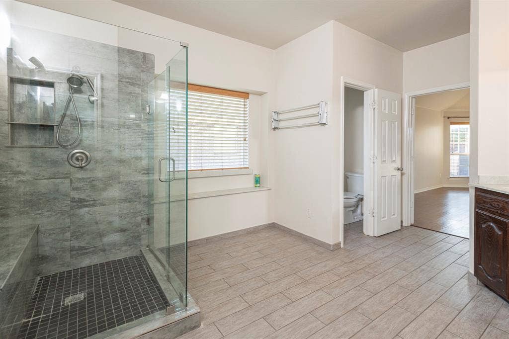 1200 Talley Lane, Frisco, TX 75033 Bathroom with a shower with shower door, vanity, toilet, and hardwood / wood-style flooring