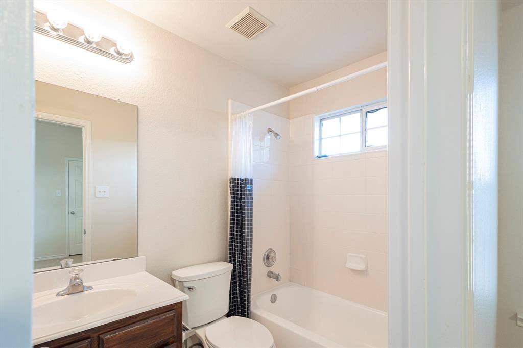 1200 Talley Lane, Frisco, TX 75033 Full bathroom featuring tiled shower / bath, vanity, and toilet