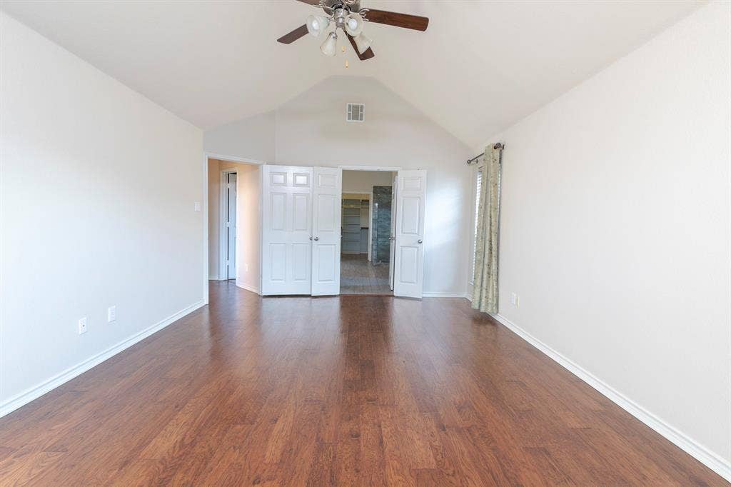 1200 Talley Lane, Frisco, TX 75033 Unfurnished bedroom with ceiling fan, dark hardwood / wood-style floors, and lofted ceiling