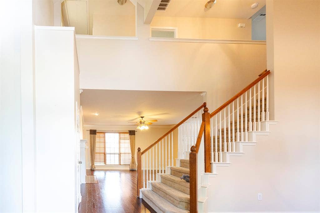 1200 Talley Lane, Frisco, TX 75033 Stairway with dark hardwood / wood-style flooring, a high ceiling, and ceiling fan