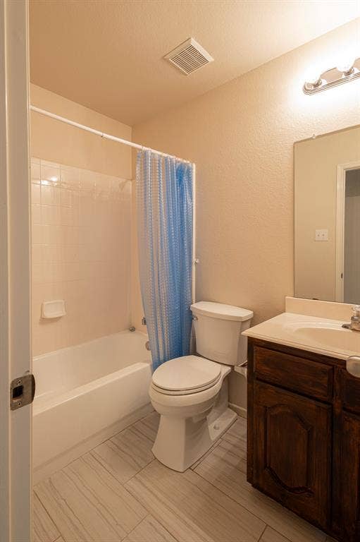 1200 Talley Lane, Frisco, TX 75033 Full bathroom with shower / bath combo with shower curtain, vanity, toilet, and tile flooring