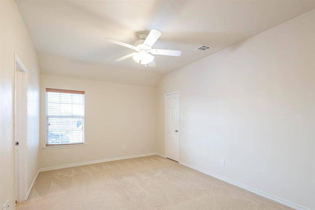 1200 Talley Lane, Frisco, TX 75033 Carpeted empty room with ceiling fan and vaulted ceiling