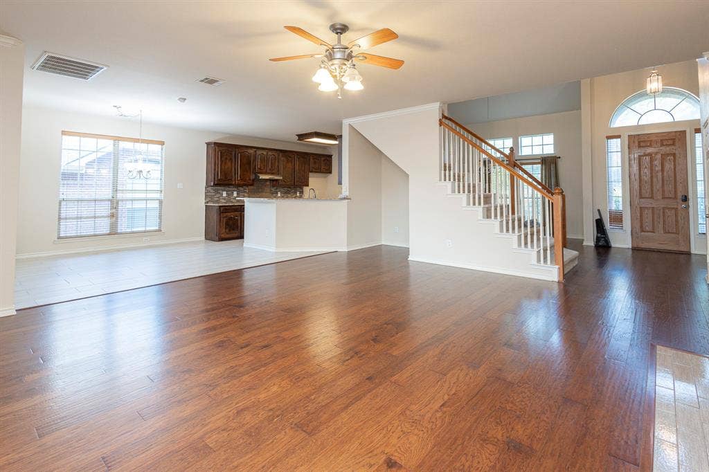 1200 Talley Lane, Frisco, TX 75033 Unfurnished living room featuring ceiling fan and dark hardwood / wood-style flooring