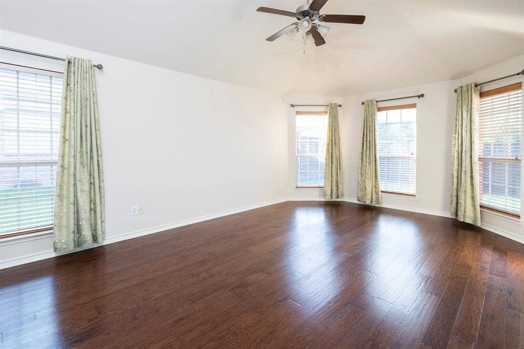 1200 Talley Lane, Frisco, TX 75033 Unfurnished room with dark wood-type flooring and ceiling fan