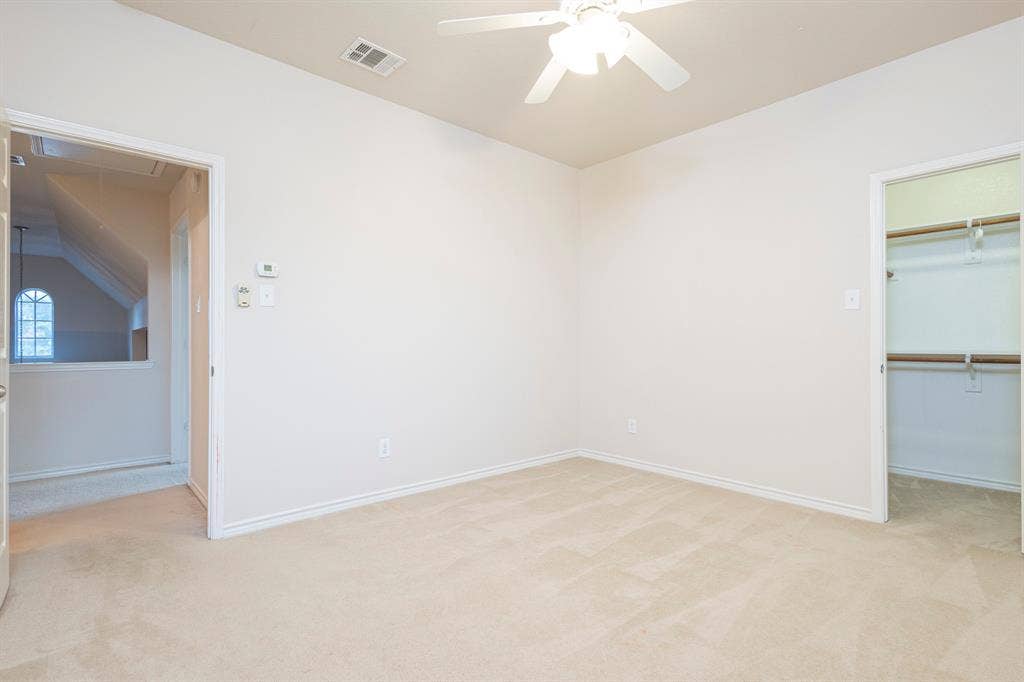 1200 Talley Lane, Frisco, TX 75033 Unfurnished bedroom featuring light carpet, a spacious closet, lofted ceiling, and ceiling fan