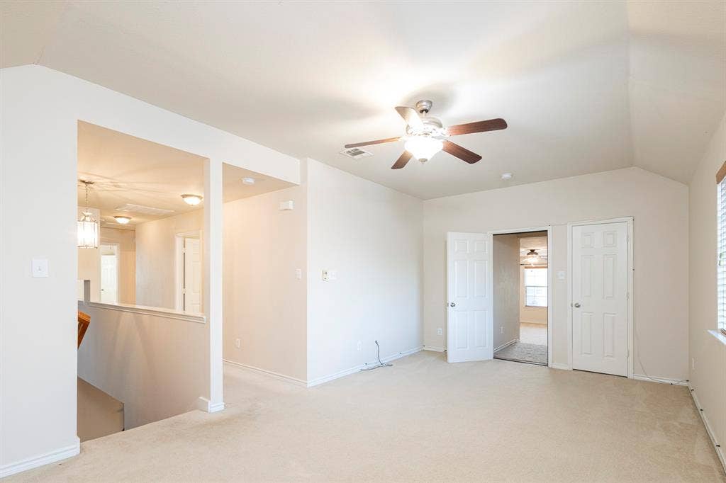 1200 Talley Lane, Frisco, TX 75033 Unfurnished room featuring light carpet, lofted ceiling, and ceiling fan