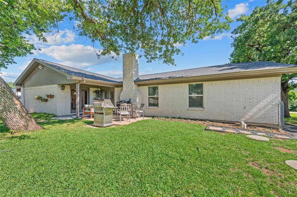 5656 Oak Haven Drive, Fort Worth, TX 76244 This patio gives you shade, scenery, and a front-row seat to the big backyard, mature trees, and firepit area