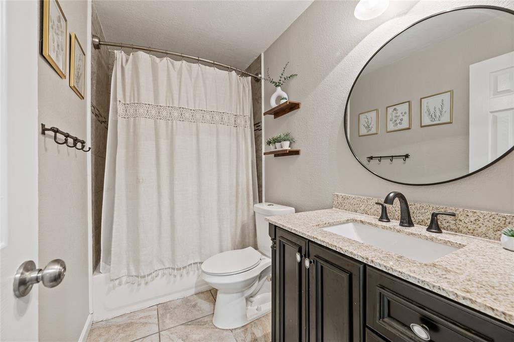 5656 Oak Haven Drive, Fort Worth, TX 76244 The hall bathroom has updated granite counters and a fresh feel that works well for guests, kids, or everyday use.