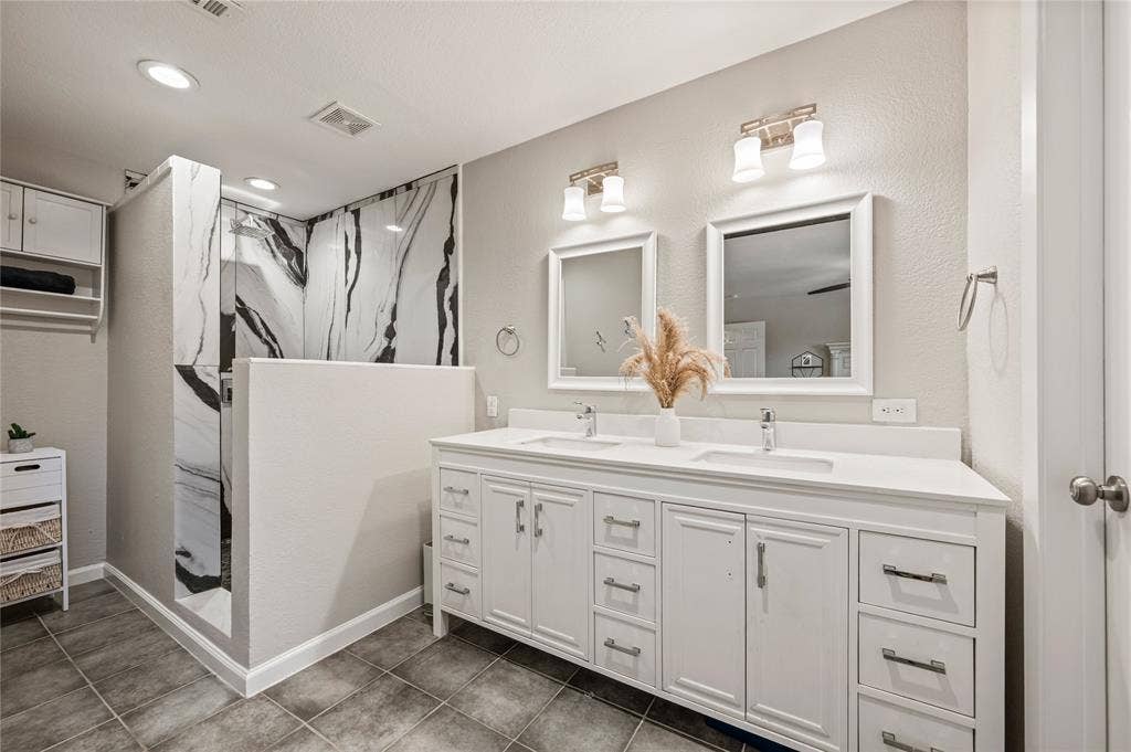5656 Oak Haven Drive, Fort Worth, TX 76244 Updated granite countertops bring a fresh feel to the primary bathroom and make the daily routine feel a little more polished.