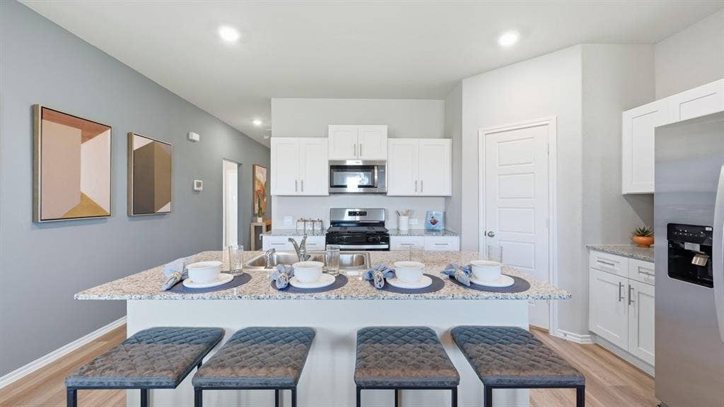 608 SMART STRIKE Trail, Granbury, TX 76049 Kitchen - All Home and community information, including pricing, included features, terms, availability and amenities, are subject to change at any time without notice or obligation. All Drawings, pictures, photographs, video, square footages, floor plans, elevations, features, colors and sizes are approximate for illustration purposes only and will vary from the homes as built.