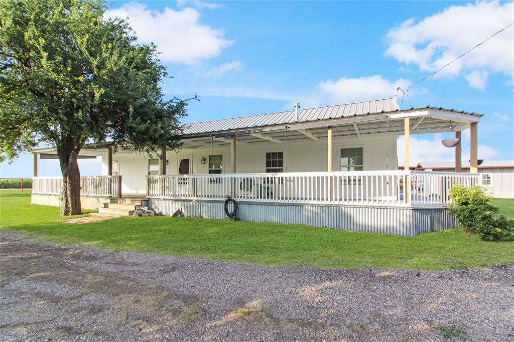 455 Hughes Cemetery Road, Italy, TX 76651 1936 HOUSE - White-sided exterior with a metal roof and an expansive lawn