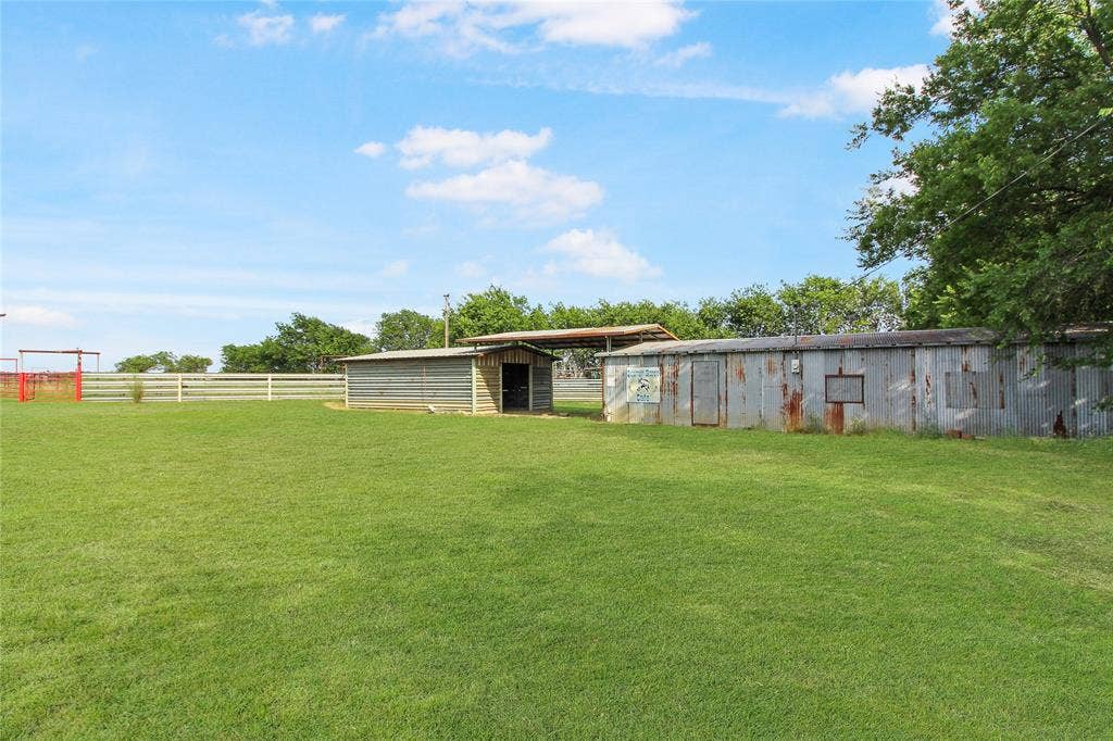 455 Hughes Cemetery Road, Italy, TX 76651 Expansive green lawn with a white perimeter fence