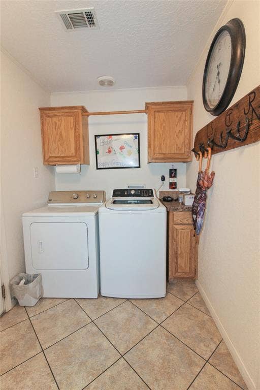 455 Hughes Cemetery Road, Italy, TX 76651 Laundry area featuring light wood-finish cabinetry, tile flooring, and a built-in hanging rod