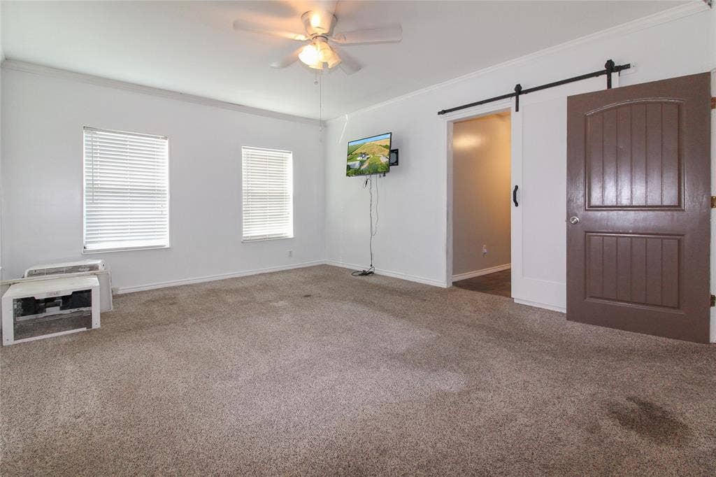 455 Hughes Cemetery Road, Italy, TX 76651 1936 HOUSE Spacious room featuring neutral carpeting, white walls, and a ceiling fan